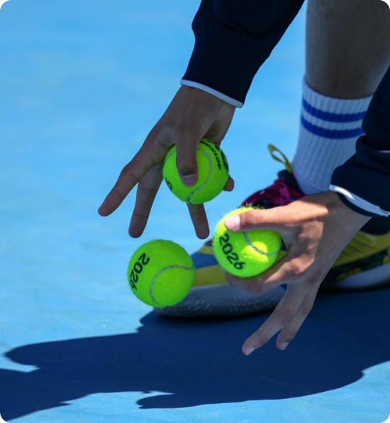 Ballkid rolling balls on court
